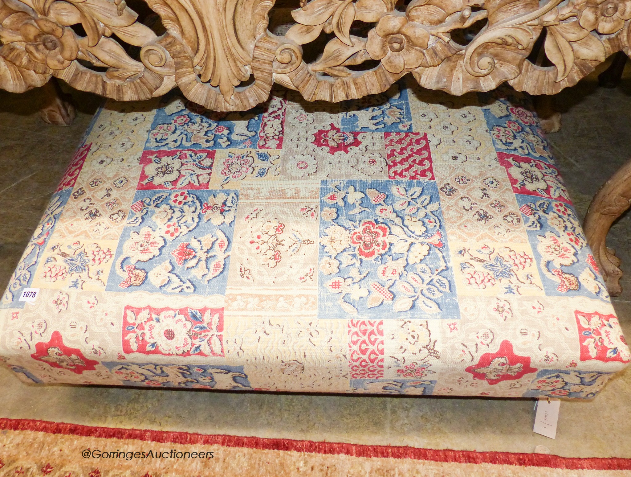 A Victorian style upholstered footstool in Andrew Martin fabric. W-103, D-95, H-28cm.